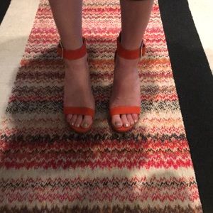 Orange Calvin Klein platform sandal heels.